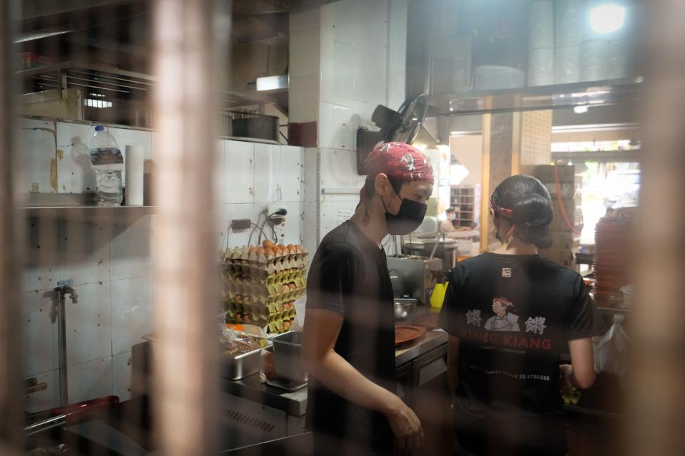 Two people working in a hawker stall.