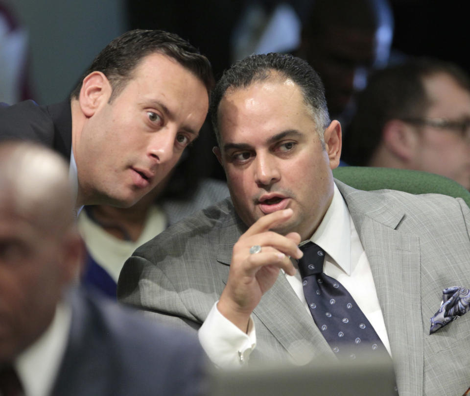 Assembly Speaker John Perez, D-Los Angeles, right, confers with Assemblyman Roger Hernandez, D-West Covina, as the Assembly debated Perez's measure to close a corporate tax loophole and used the money for college scholarships, at the Capitol in Sacramento, Calif., Monday, Aug. 13, 2012. The measure, AB1500, eliminates a $1 billion tax break for out-of-state corporations and uses the money for college scholarships for families earning between $80,000-$100,000, was approved 54-25 and sent to the Senate. (AP Photo/Rich Pedroncelli)