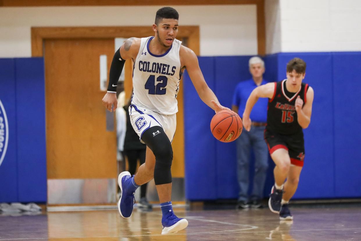 Covington Catholic forward Chandler Starks (42) dribbles against La Salle in the second half at Covington Catholic High School Dec. 10, 2021.