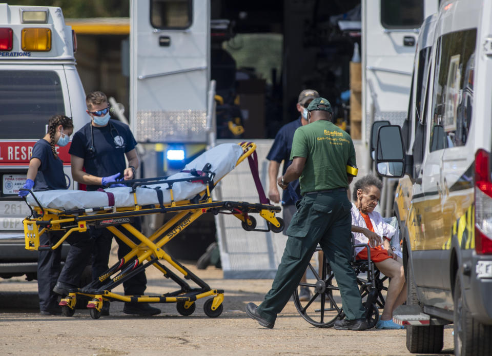 Paramedics standby at a mass shelter where about 800 residents were reportedly packed into a warehouse for Hurricane Ida, Thursday, Sep.t 2, 2021 in New Orleans. Multiple nursing home residents died after Hurricane Ida, but full details of their deaths are unknown because state health inspectors said Thursday that they were turned away from examining conditions at the facility to which they had been evacuated. (Chris Granger/The Times-Picayune/The New Orleans Advocate via AP)