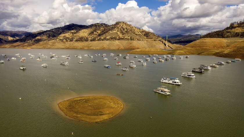 Houseboats float on Lake Oroville, Monday, Oct. 25, 2021, in Oroville, Calif. Recent storms raised the reservoir more than 16 feet, according to the California Department of Water Resources. (AP Photo/Noah Berger)