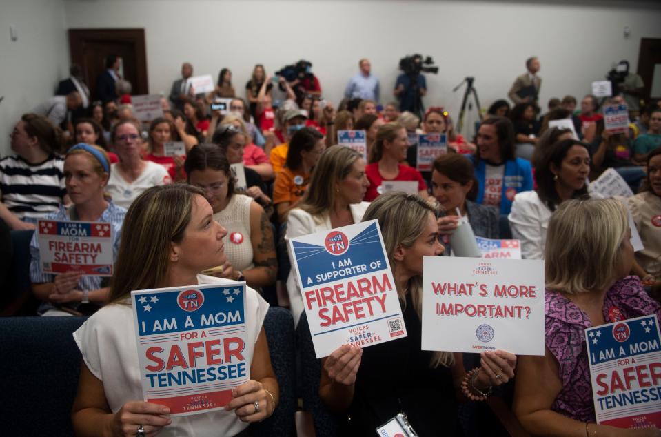 Supporters of gun safety reform hold signs during committee meetings at Cordell Hull State Office Building on Wednesday, Aug. 23, 2023, in Nashville, Tenn.