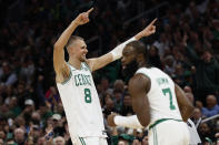 Kristaps Porzingis celebrates after making a 3-point basket against the Oklahoma City Thunder during the first half of an NBA basketball game Wednesday, April 3, 2024, in Boston. (AP Photo/Winslow Townson)