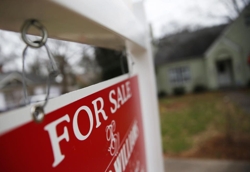 FILE - This Jan. 26, 2016 file photo shows a "For Sale" sign hanging in front of an existing home in Atlanta.  Short of savings and burdened by debt, America's millennials are struggling to afford their first homes in the face of sharply higher prices in many of the most desirable cities. Surveys show that most Americans under 35 lack adequate savings for down payments. The result is that many will likely be forced to delay home ownership and to absorb significant debt loads if they do eventually buy. (AP Photo/John Bazemore, File)