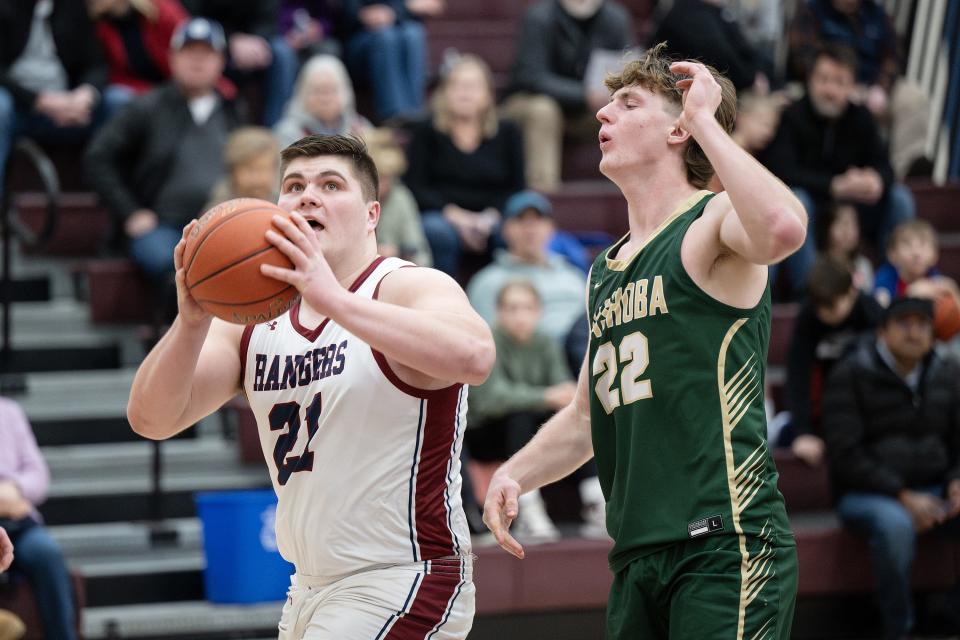 Westborough's Joe Marino pushes to the basket as Nashoba's Nowlan Losty defends.