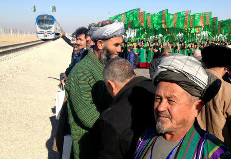 People attend the opening ceremony of a railway link to Afghanistan in the Ymamnazar customs control point, Turkmenistan, November 28, 2016. REUTERS/Marat Gurt