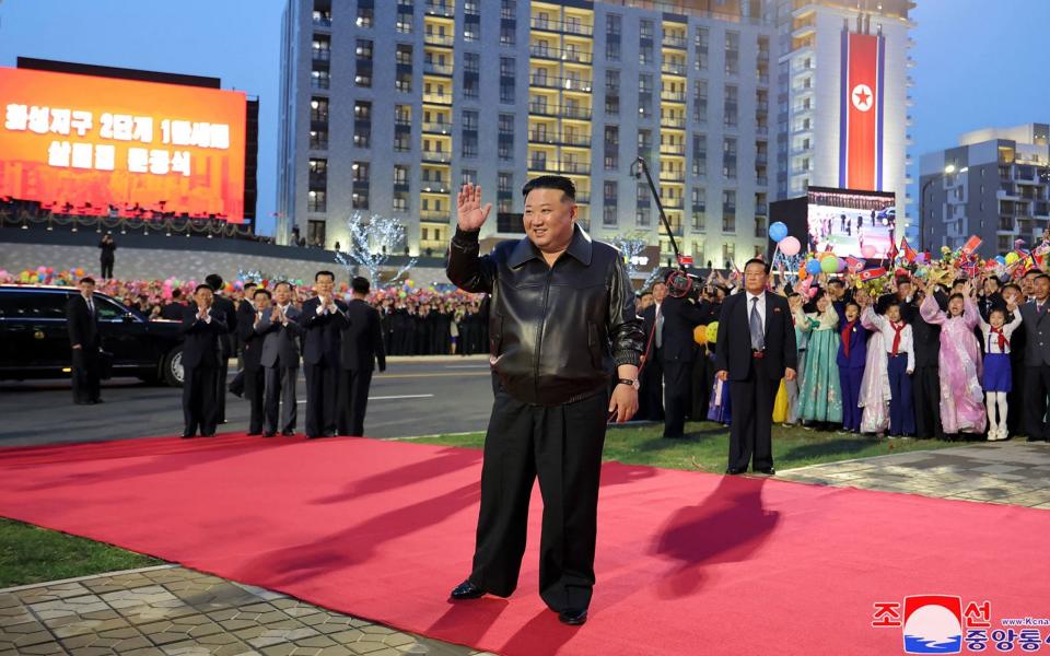 Kim Jong-un arrives at a ceremony marking the opening of a new housing estate