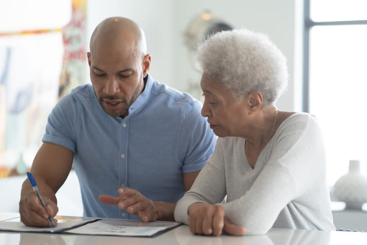 A senior woman reviewing her estate plan with her son.