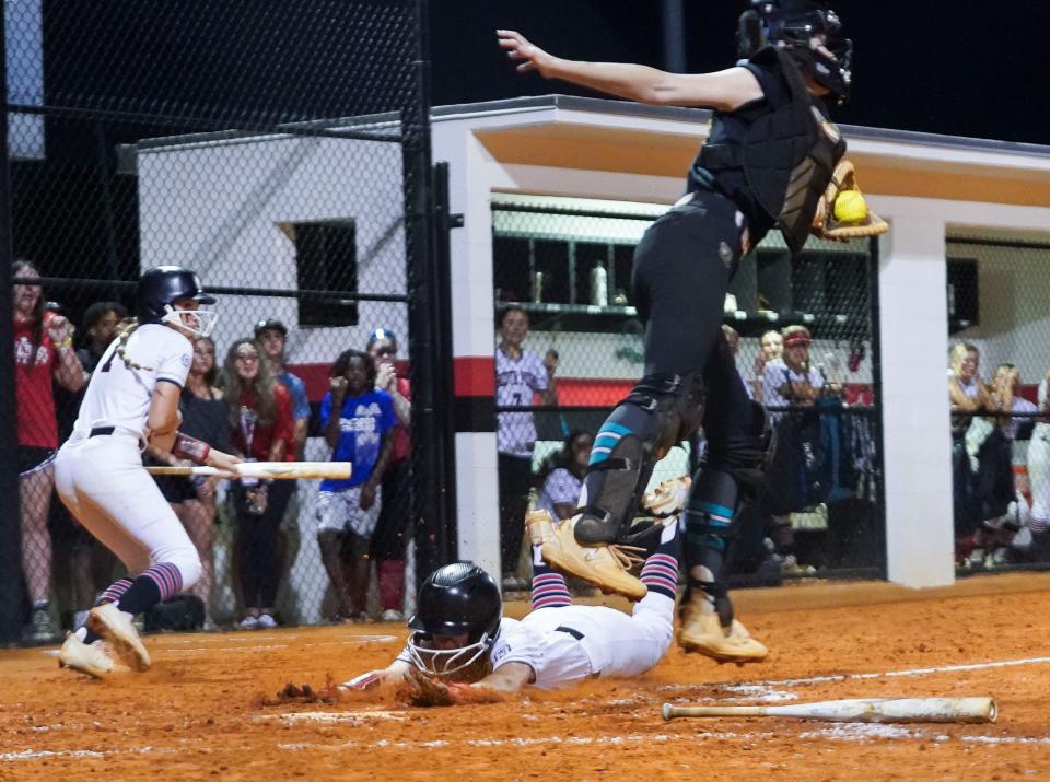 South Fork's Alice Dewaters slides into home plate for a run against Bayside in a softball Regional 4-5A semifinal, Tuesday, May, 16, 2023, at South Fork High School in Martin County.