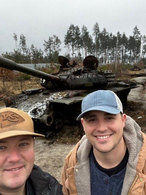 Springfield firefighters Jeffrey Weeks, left, and Eli Davidson in front of a disabled tank in war-torn Ukraine.
(Credit: Provided by Jeffrey Weeks)