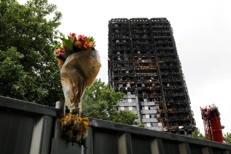 FILE PHOTO: A floral tribute is seen near the Grenfell Tower, which was destroyed in a fatal fire, in London, Britain July 15, 2017.  REUTERS/Tolga Akmen/File Photo