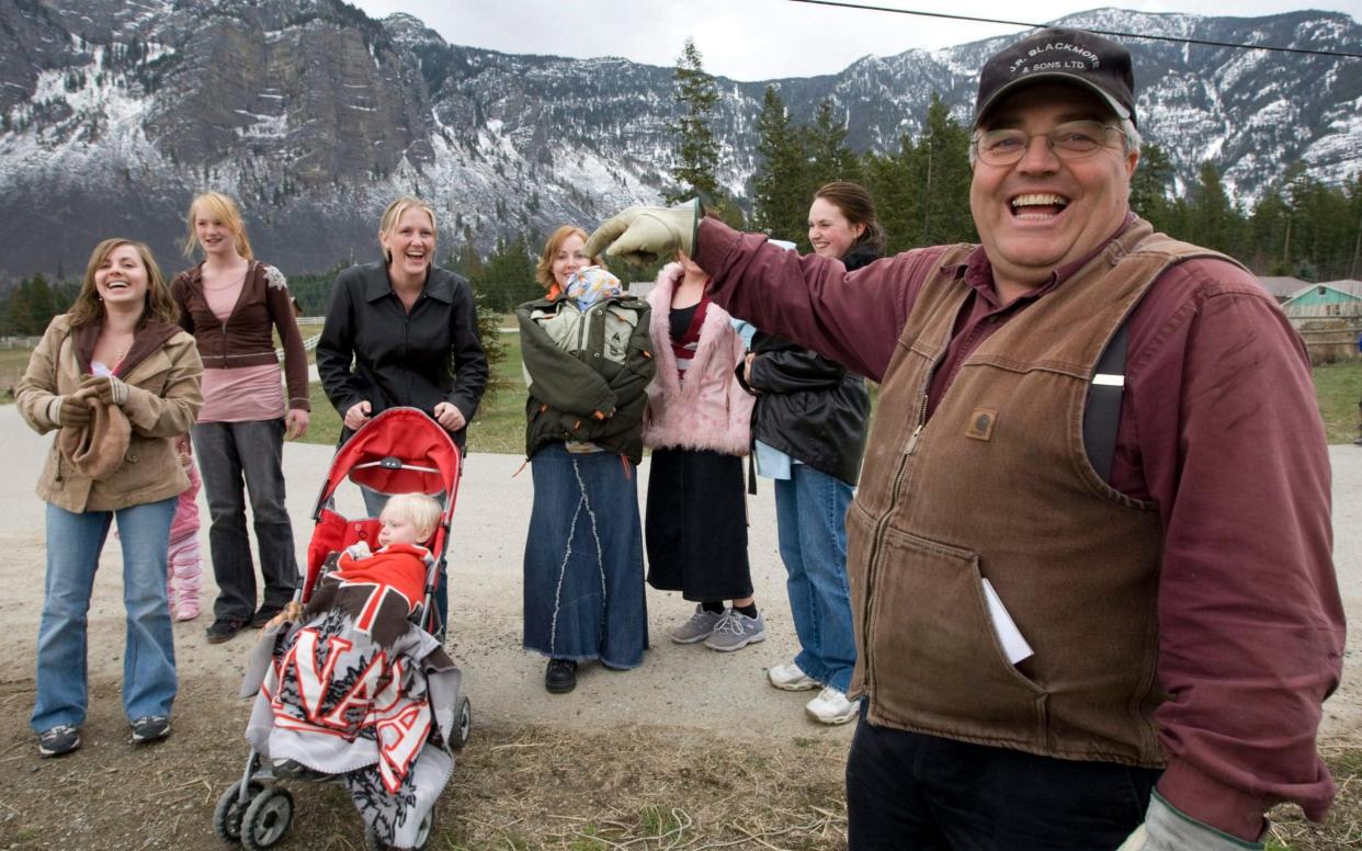 Winston Blackmore, the religious leader of the controversial polygamous community of Bountiful located near Creston, British Columbia, Canada, shares a laugh with six of his daughters and some of his grandchildren - The Canadian Press
