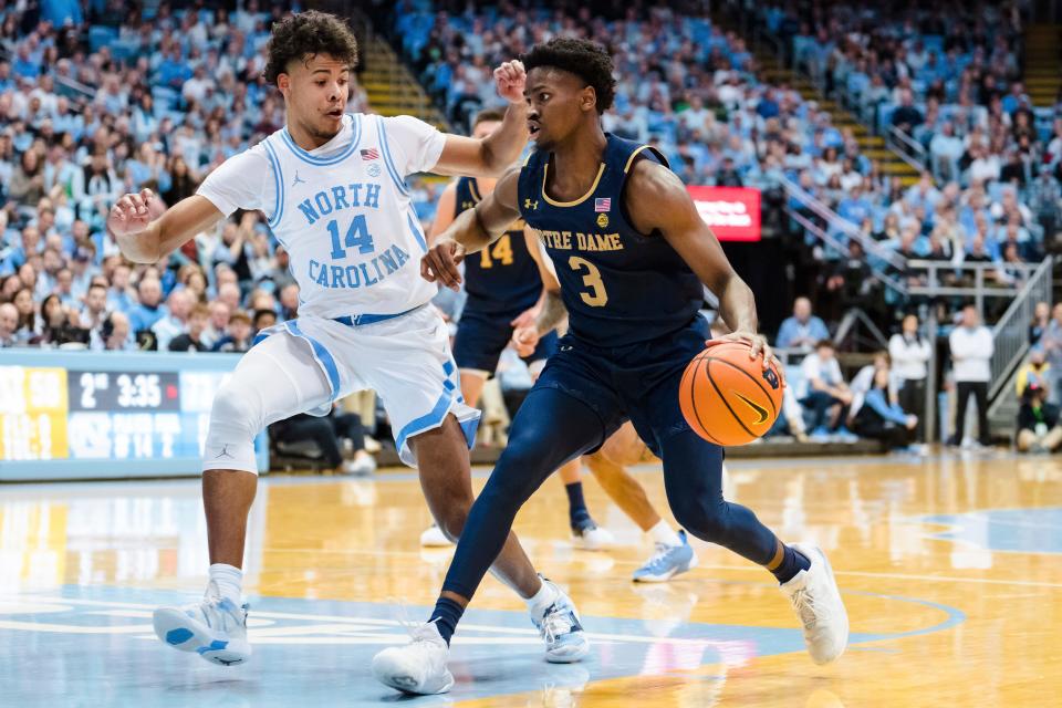 North Carolina forward Puff Johnson (14) guards Notre Dame guard Trey Wertz (3) in the second half of an NCAA college basketball game on Saturday, Jan. 7, 2023, in Chapel Hill, N.C. (AP Photo/Jacob Kupferman)