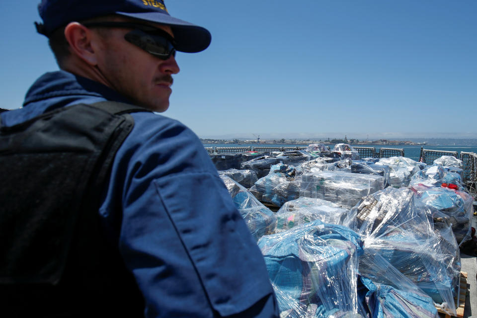 A Coast Guard agent watches over more than 13 tons of cocaine seized off the coasts of Mexico and Central South America before they are unloaded from the Coast Guard Cutter Steadfast at port in San Diego on Friday. (Photo: Mike Blake / Reuters)