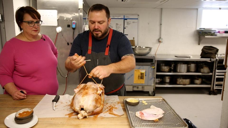 Chef Brandon Carter, executive chef for Farm Group, prepares a 17 pound organic, free range turkey for the smoker.