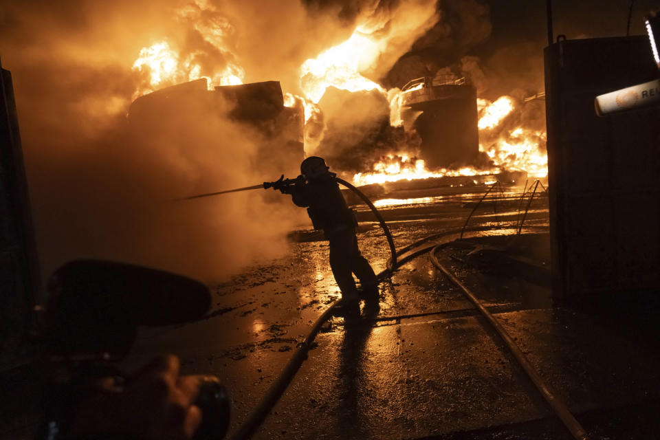 Firefighters extinguish a fire after a Russian attack on a residential neighborhood in Kharkiv, Ukraine Saturday, Feb. 10, 2024. (AP Photo/Yevhen Titov)