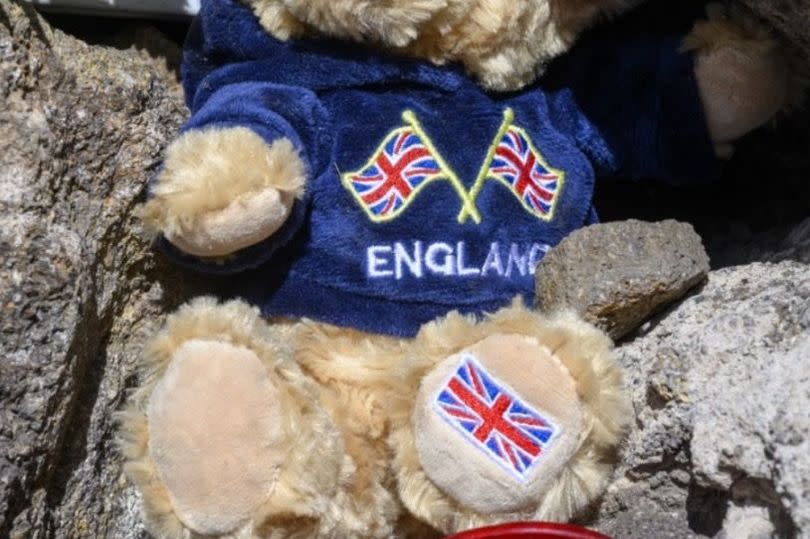 A little teddy bear with the word 'England' and British flags on it had also been left near the messages -Credit:Jonathan Buckmaster