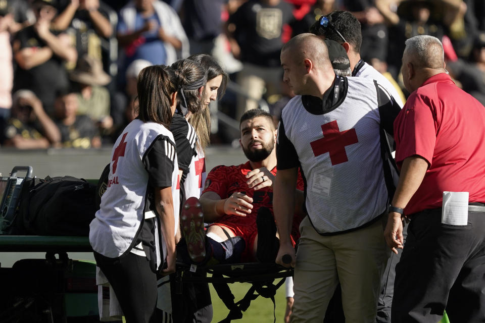 FILE - Los Angeles FC goalkeeper Maxime Crépeau, cemter, is removed after sustaining an injury in extra during the MLS Cup soccer match against the Philadelphia Union on Nov. 5, 2022, in Los Angeles. Crépeau is almost fully healed from the broken leg that sent him to the hospital deep into extra time at the MLS Cup final late last year. He hopes to play again before June 2023. (AP Photo/Marcio Jose Sanchez, File)