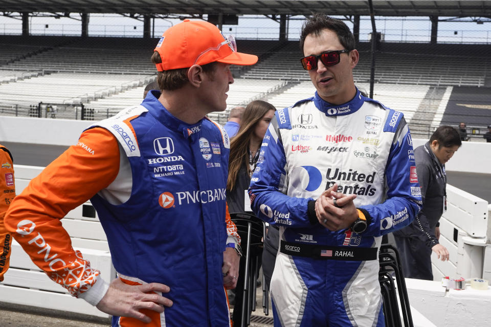 Scott Dixon, of New Zealand, left, talks with Graham Rahal before practice for the Indianapolis 500 auto race at Indianapolis Motor Speedway, Monday, May 23, 2022, in Indianapolis. (AP Photo/Darron Cummings)