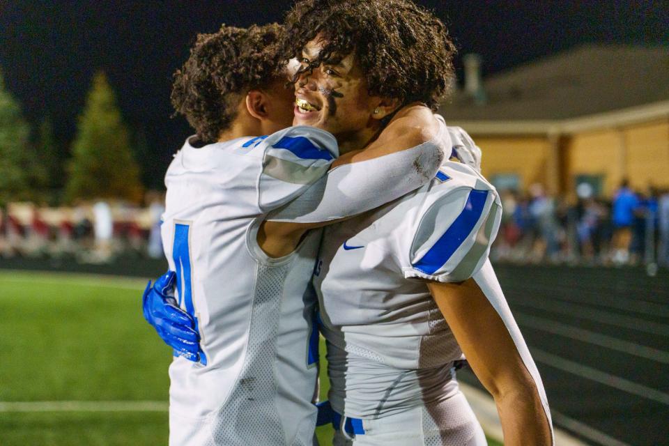 Hamilton Southeastern Royals' Jalen Alexander (24) gives a hug to teammate Donovan Hamilton (1) on Friday, Nov. 4, 2022, as the time ticks down in their Class 6A Sectional 3 championship against the Fishers Tigers' at Fishers High School.