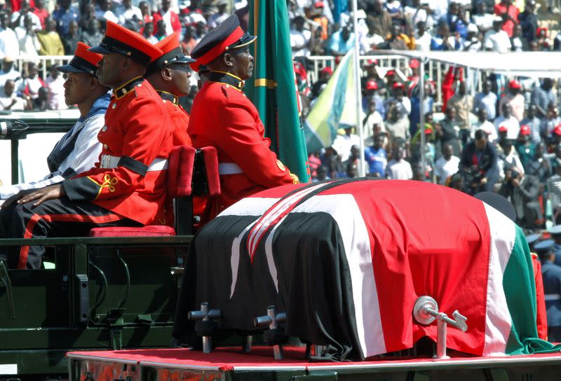 Military officers escort a gun carriage carrying the coffin of late former Kenya's President Daniel Arap Moi, draped in the national flag, during a state funeral procession to the Nyayo Stadium, the venue of the national memorial service in Nairobi