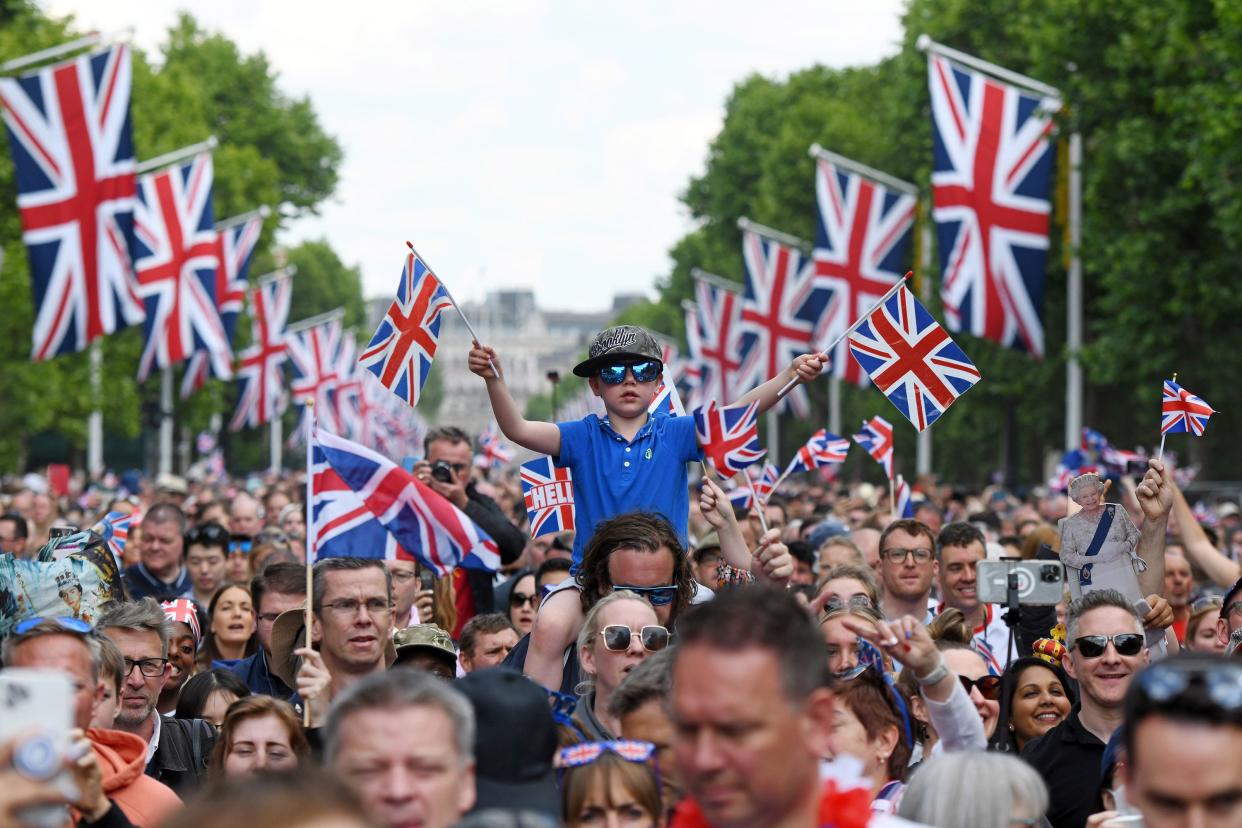 Members of the public walk up The Mall towards Buckingham Palace during the Trooping the Colour parade on June 02, 2022, in London, England. The Platinum Jubilee of Elizabeth II is being celebrated from June 2 to June 5, 2022, in the UK and Commonwealth to mark the 70th anniversary of the accession of Queen Elizabeth II on 6 February 1952.