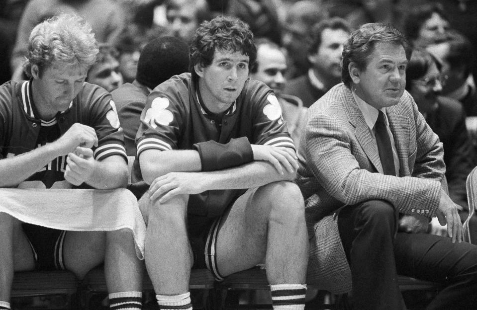 FILE - In this Dec. 21, 1982, file photo, Boston Celtics coach Bill Fitch and players Rick Robey, center, and Larry Bird watch from the bench as their team loses to the Philadelphia 76ers 122-105 in an NBA basketball game Philadelphia. Fitch is among 13 finalists for enshrinement later this year into the Basketball Hall of Fame. (AP Photo/Peter Morgan, File)