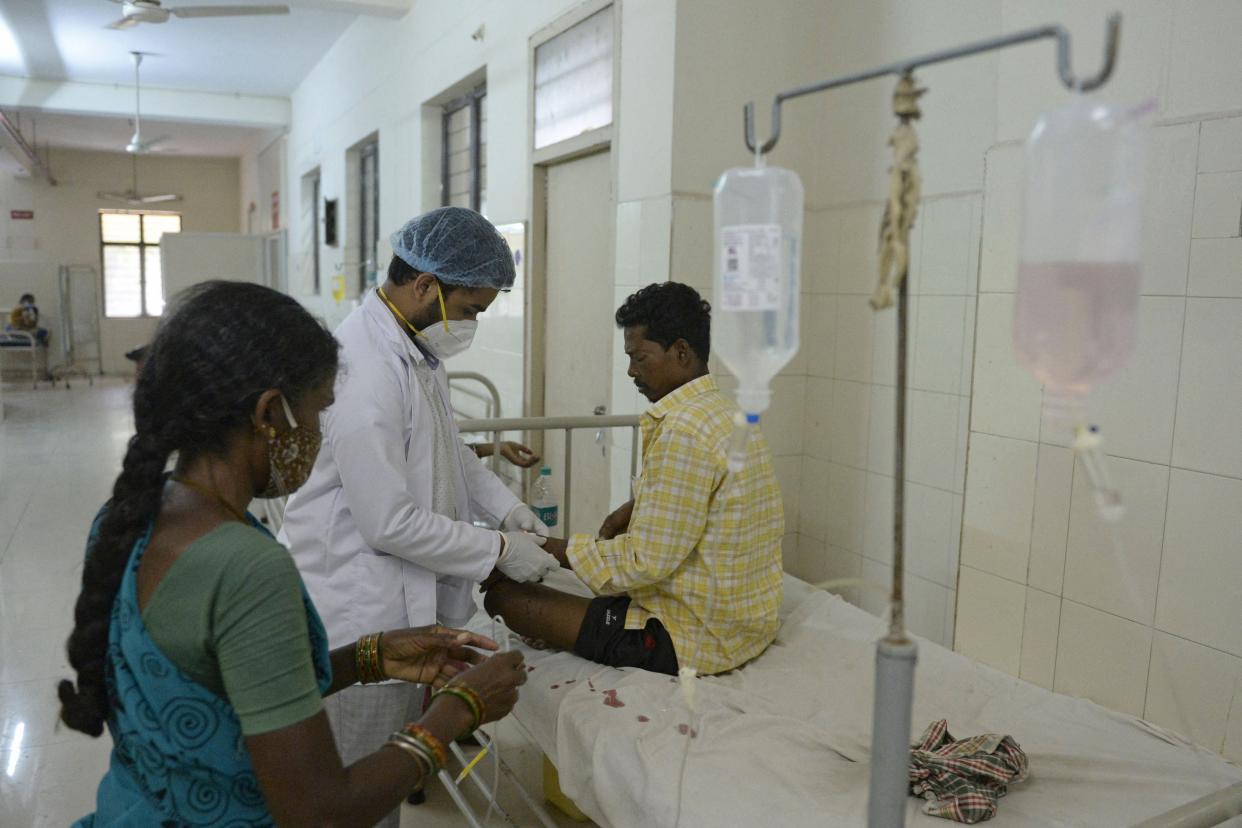 <p>A doctor examines a patient who recovered from Covid-19 and is now infected with black fungus at a hospital in Hyderabad on 21 May, 2021</p> (AFP via Getty Images)