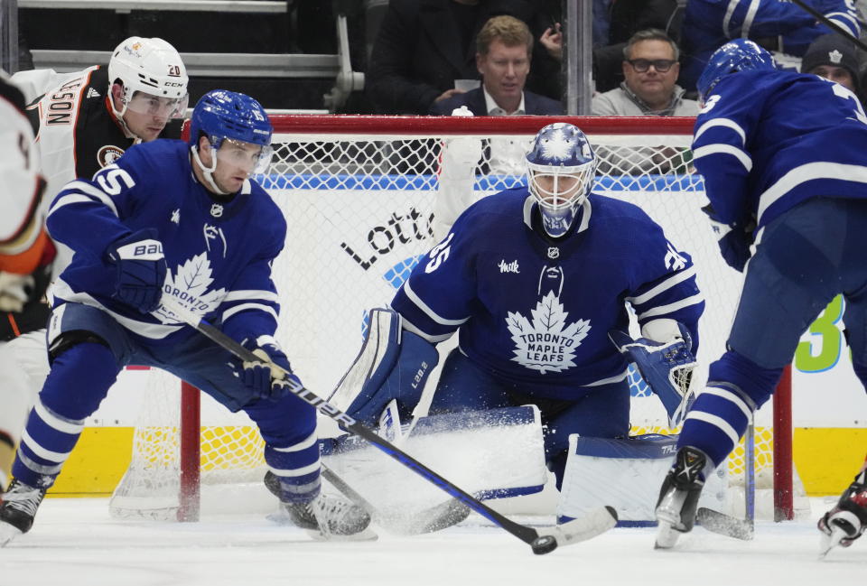 Toronto Maple Leafs' Alexander Kerfoot (15) plays the puck as Anaheim Ducks' Brett Leason (20) and Maple Leafs goaltender Ilya Samsonov (35) look on during the second period of an NHL hockey game in Toronto on Tuesday, Dec. 13, 2022. (Frank Gunn/The Canadian Press via AP)