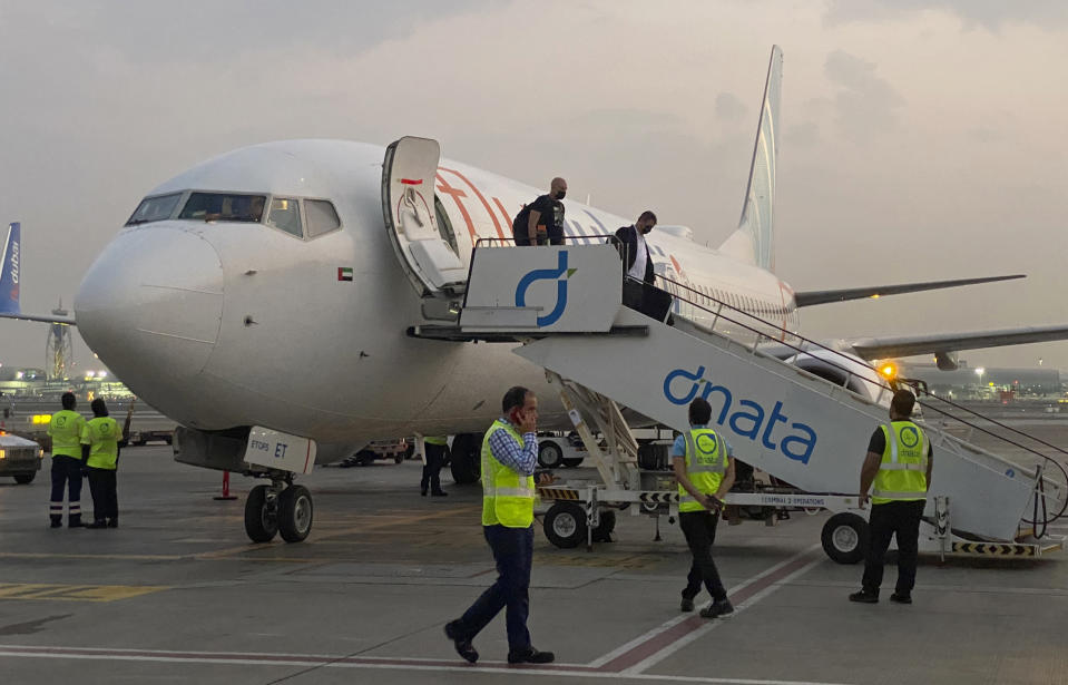 FILE - Israeli tourists leave a flydubai plane which departed from Ben-Gurion International Airport in Tel Aviv and landed in Dubai, United Arab Emirates, Sunday, Nov. 8, 2020. The Israeli government is urging its citizens to avoid travel to the Gulf states of the United Arab Emirates and Bahrain, citing threats of Iranian attacks. Thursday, Dec. 3, travel advisory comes as Iran is threatening to attack Israeli targets following the assassination of its top nuclear scientist last Friday. (AP Photo/Malak Harb, File)