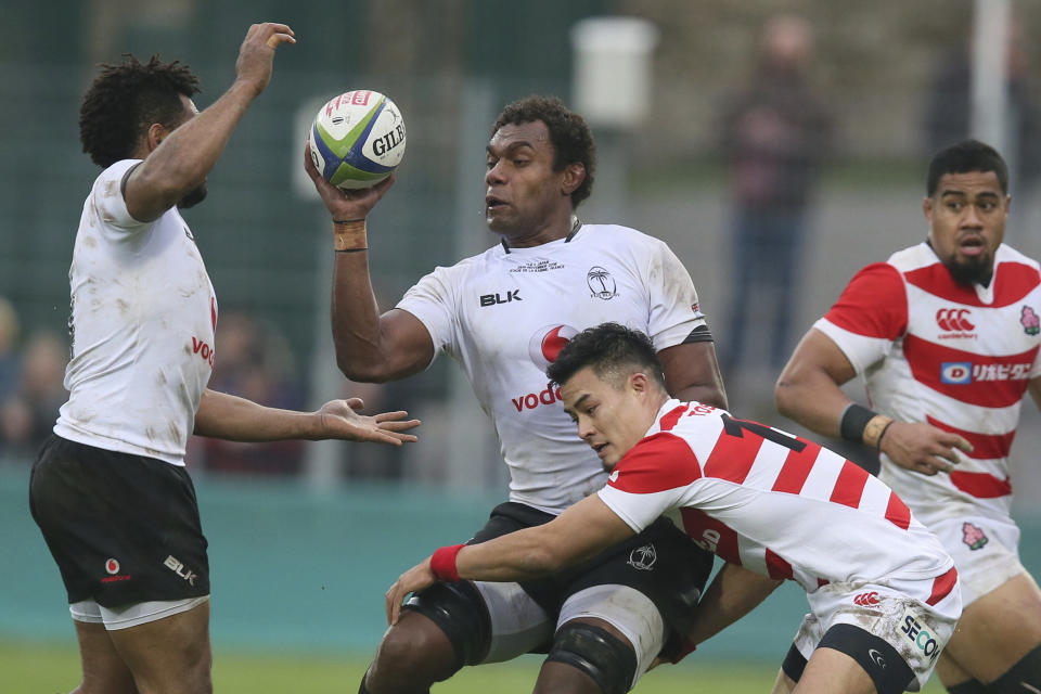 FILE - In this Nov. 26, 2016, file photo, Fiji's Leone Nakarawa, center, catches the ball during an international rugby union test match between Fiji and Japan at Stade de la Rabine in Vannes, western France. Teams from the Pacific islands are immensely popular around the world and their appearances at the Rugby World Cup are likely to attract large and admiring crowds. But an appreciative welcome won't disguise the fact that the Pacific nations begin the tournament under a considerable handicap. (AP Photo/David Vincent, File)