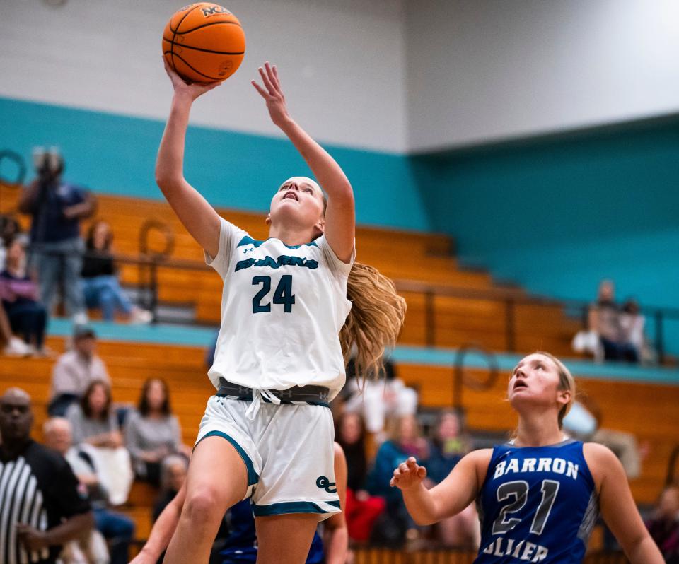 Gulf Coast Sharks forward Kali Cleary (24) shoots a lay up during the first quarter of a game against the Barron Collier Cougars at Gulf Coast High School in Naples on Tuesday, Dec. 12, 2023.