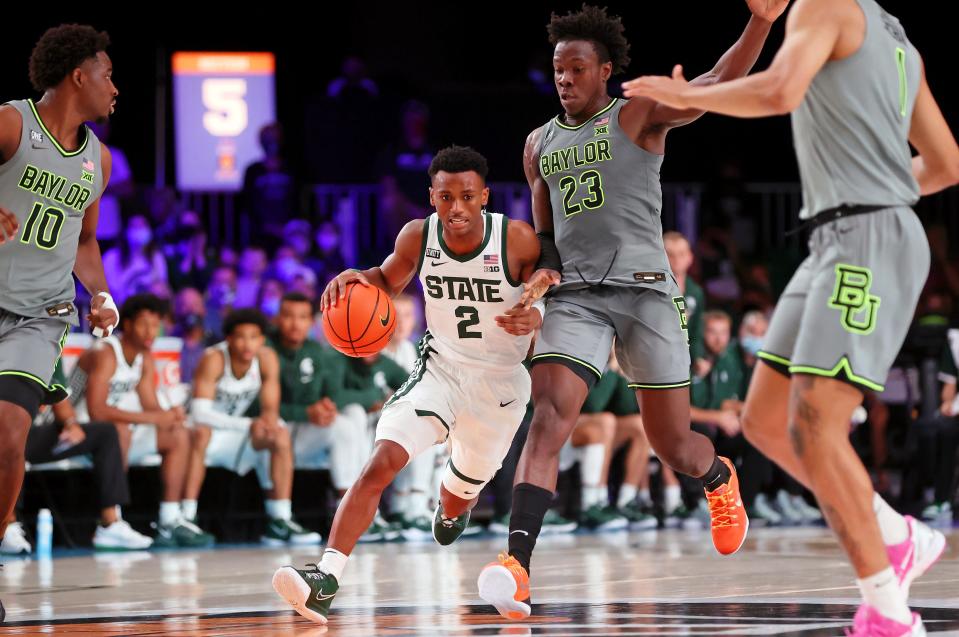 Michigan State Spartans guard Tyson Walker (2) dribbles the ball while defended by Baylor Bears forward Jonathan Tchamwa Tchatchoua (23) during the first half Nov. 26, 2021 at Imperial Arena.