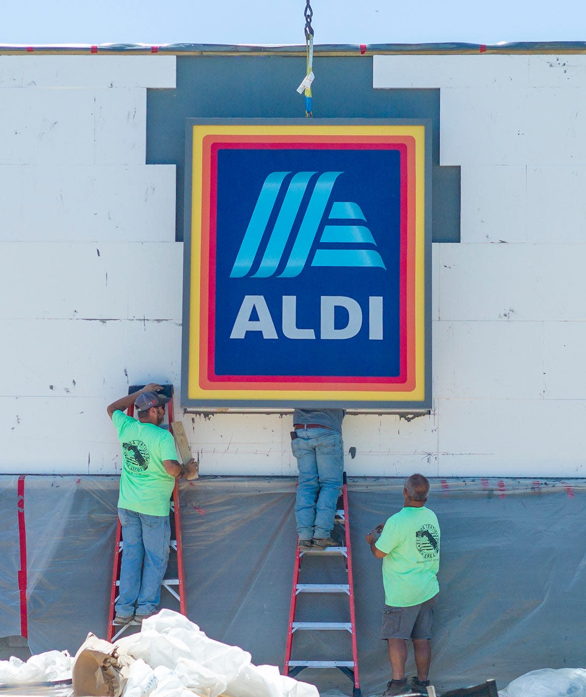 Workers recently installed signage to a wall at the new Aldi grocery store at 1030 John Sims Parkway in Niceville. The store's grand opening is scheduled for 9 a.m. June 23.