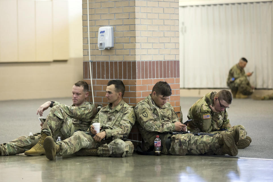 Soldiers with the U.S. Army 3rd Infantry Division, 1st Armored Brigade Combat Team wait before being deployed to Germany from Hunter Army Airfield, Wednesday March 2, 2022 in Savannah, Ga. The division is sending 3,800 troops as reinforcements for various NATO allies in Eastern Europe. (Stephen B. Morton /Atlanta Journal-Constitution via AP)