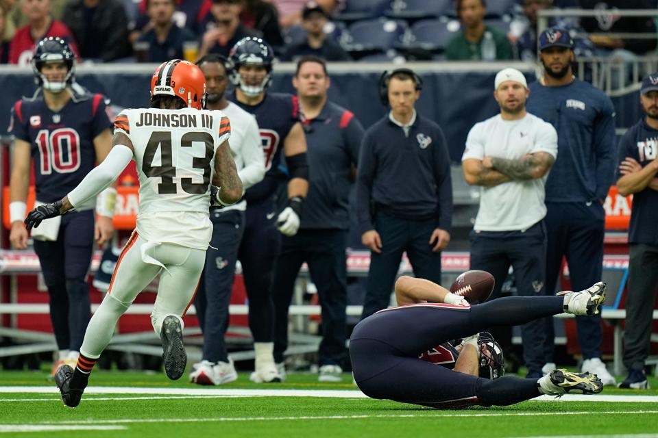 Houston Texans tight end Teagan Quitoriano (84) drops a pass and recovered by Cleveland Browns safety John Johnson III during the first half of an NFL football game between the Cleveland Browns and Houston Texans in Houston, Sunday, Dec. 4, 2022,. (AP Photo/Eric Gay)