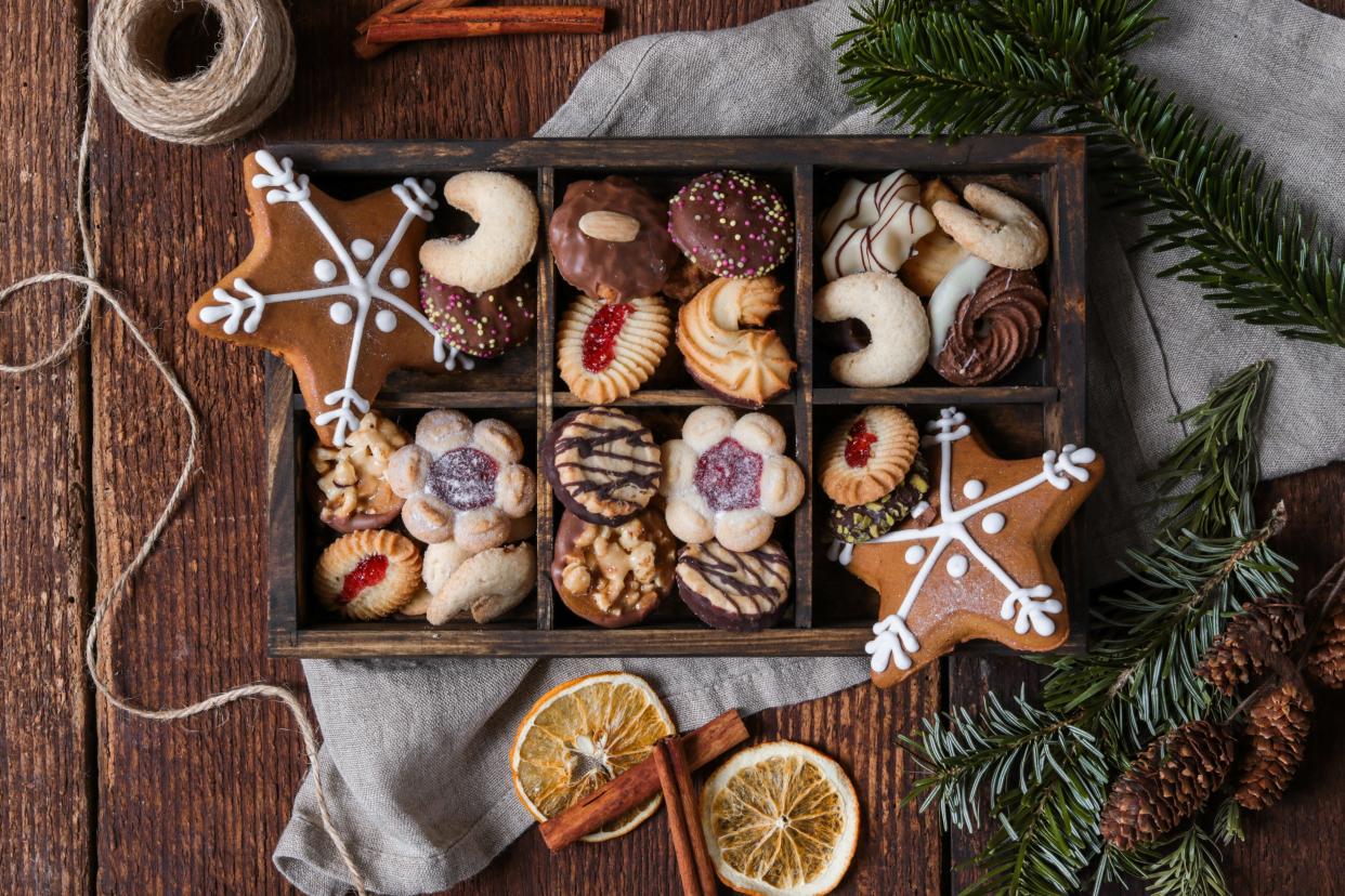 Christmas cookie box with gingerbread in rustic wood kitchen.