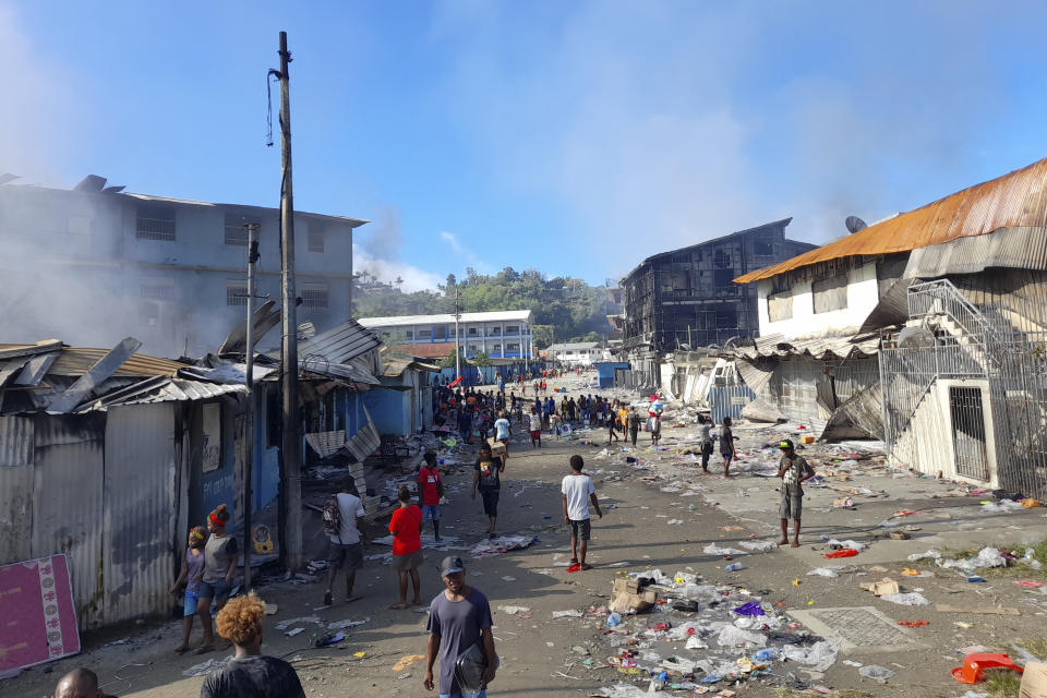 FILE - In this image made from aerial video, smoke rises from burning buildings during a protest in the capital of Honiara, Solomon Islands, Thursday, Nov. 25, 2021. Prime Minister Manasseh Sogavare declared a lockdown after about 1,000 people took to the streets in the capital for a second day, demanding his resignation over a host of domestic issues, according to local media reports. (Australian Broadcasting Corporation via AP, File)