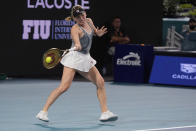 Ekaterina Alexandrova, of Russia, returns a shot from Iga Swiatek, of Poland, during the Miami Open tennis tournament, Monday, March 25, 2024, in Miami Gardens, Fla. (AP Photo/Wilfredo Lee)