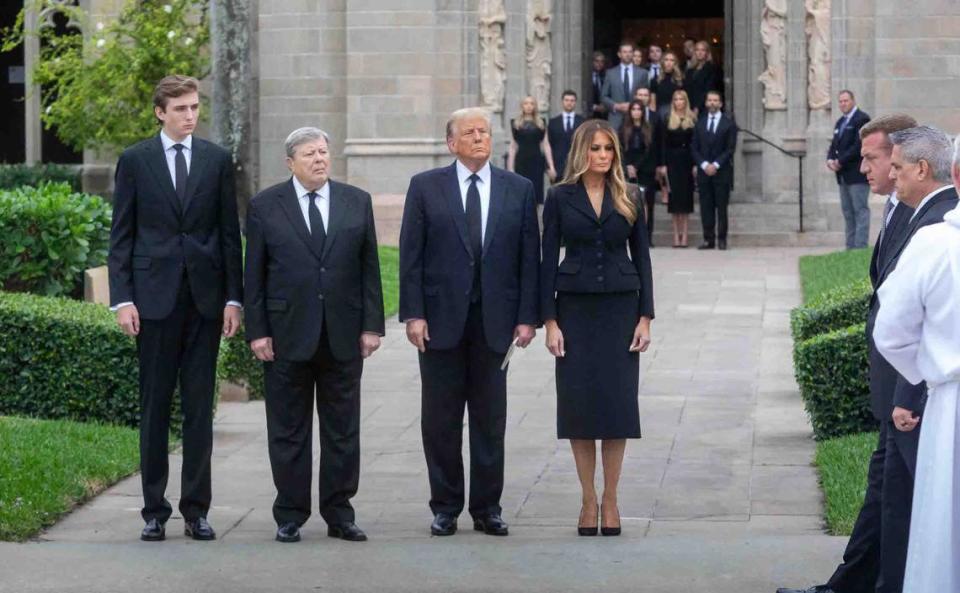 (l-r) Barron Trump, Viktor Knavs, former President Donald Trump, and Melania Trump, wait for pallbearers to finish loading the casket for Amalia Knavs, MelaniaÕs mother, into a hearse January 18, 2024.