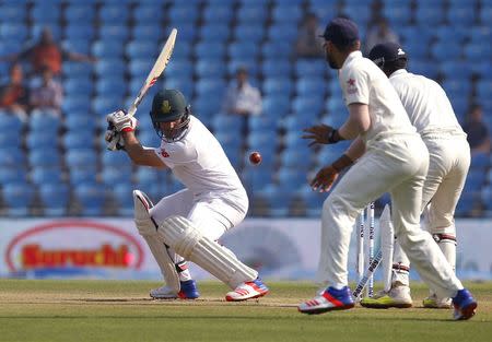 South Africa's Dean Elgar (L) is bowled by India's Ravichandran Ashwin (not pictured) during the second day of their third test cricket match in Nagpur, India, November 26, 2015. REUTERS/Amit Dave -