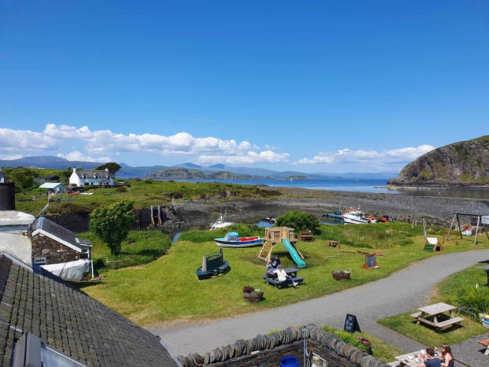 A view of the island with a playground and a couple of houses.