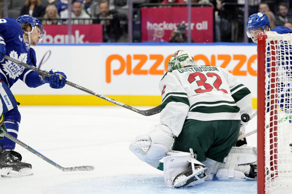 Toronto Maple Leafs left wing Tyler Bertuzzi (59) scores on Minnesota Wild goaltender Filip Gustavsson (32) during second period of an NHL hockey game, in Toronto, Saturday, Oct. 14, 2023. (Frank Gunn/The Canadian Press via AP)