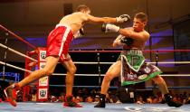 KISSIMMEE, FL - OCTOBER 19: Boxer Orlando Cruz (R) trades punches with boxer Jorge Pazos at Kissimmee Civic Center on October 19, 2012 in Kissimmee, Florida. (Photo by J. Meric/Getty Images)