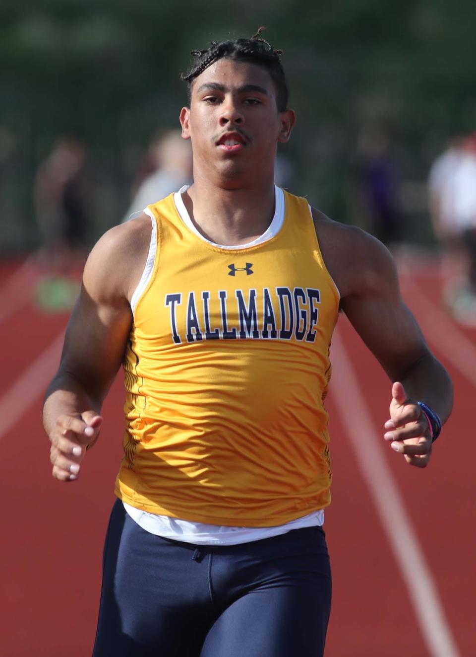 Collin Dixon of Tallmadge runs to a first place finish in the 100 meter dash with a time of 11.26 seconds during the Suburban League American Conference Meet at Tallmadge High School in Tallmadge on Tuesday. 