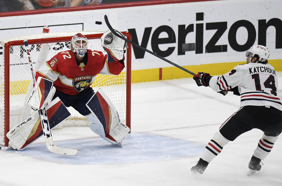 Florida Panthers goaltender Sergei Bobrovsky (72) catches the puck in front of Chicago Blackhawks left wing Boris Katchouk (14) during the second period of an NHL hockey game, Friday, March 10, 2023, in Sunrise, Fla. (AP Photo/Michael Laughlin)