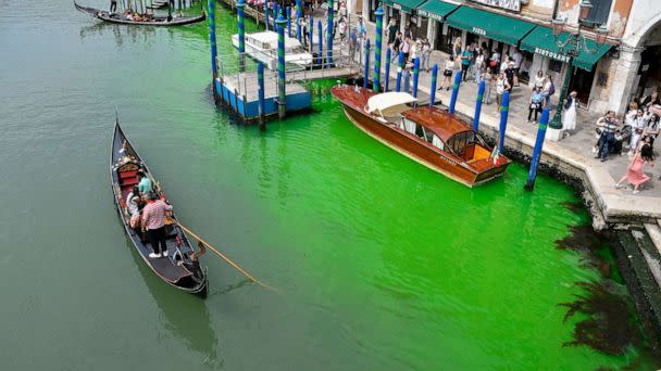 PHOTO: A gondola navigates along Venice's historical Grand Canal as a patch of phosphorescent green liquid spreads in it, May 28, 2023, in Venice, Italy. (Luigi Costantini/AP)