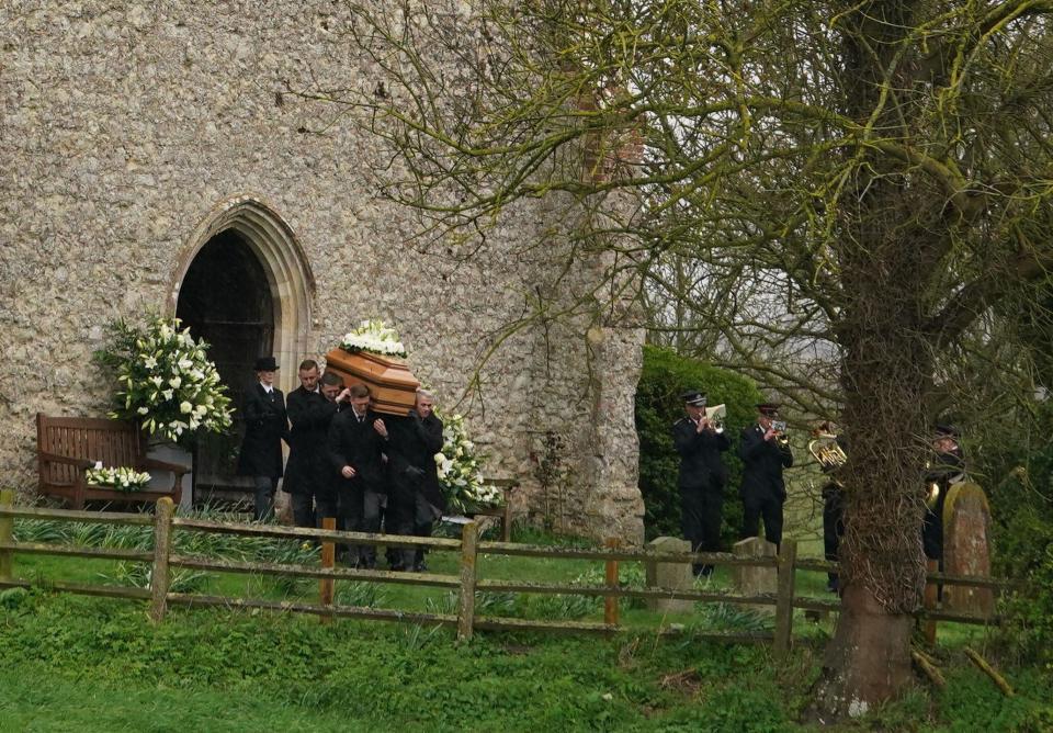 The coffin of Paul O'Grady is taken from St Rumwold's Church in Aldington, Kent, following his funeral service. Picture date: Thursday April 20, 2023.