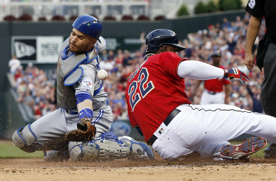 <p>Toronto Blue Jays catcher Russell Martin, left, can’t pull in the throw to the plate as Minnesota Twins’ Miguel Sano scores on an RBI double by Robbie Grossman off Blue Jays pitcher Aaron Sanchez in the second inning of a baseball game, May 20, 2016, in Minneapolis. (Jim Mone/AP) </p>