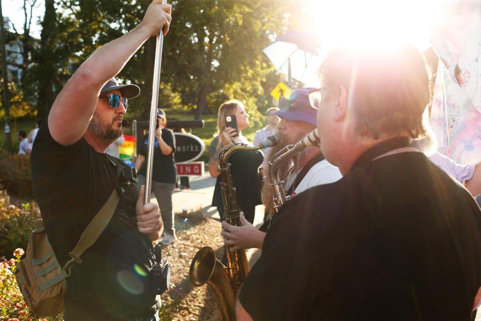 Protesters against the Athens Pride and Queer Collective's Athens Pride Week Kids and Youth Night Drag Story Hour are meet with counter-protesters from the APQC with saxophones outside of Hendershot's Coffee in Athens, Ga., on Wednesday, Sept. 14, 2022.